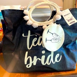Team bride hand bag. Brand new with tags. Detachable coin purse. Inside pocket.